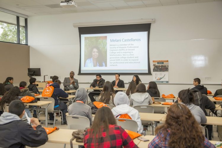 CEI team members presenting to a room of students.