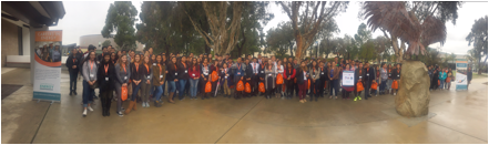 Students pose for a large group photo by a Careers in Energy banner.