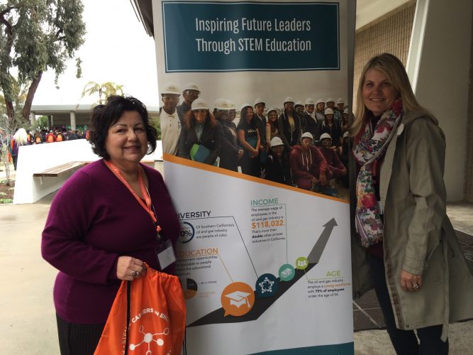 Volunteers standing in front of a STEM Education banner.